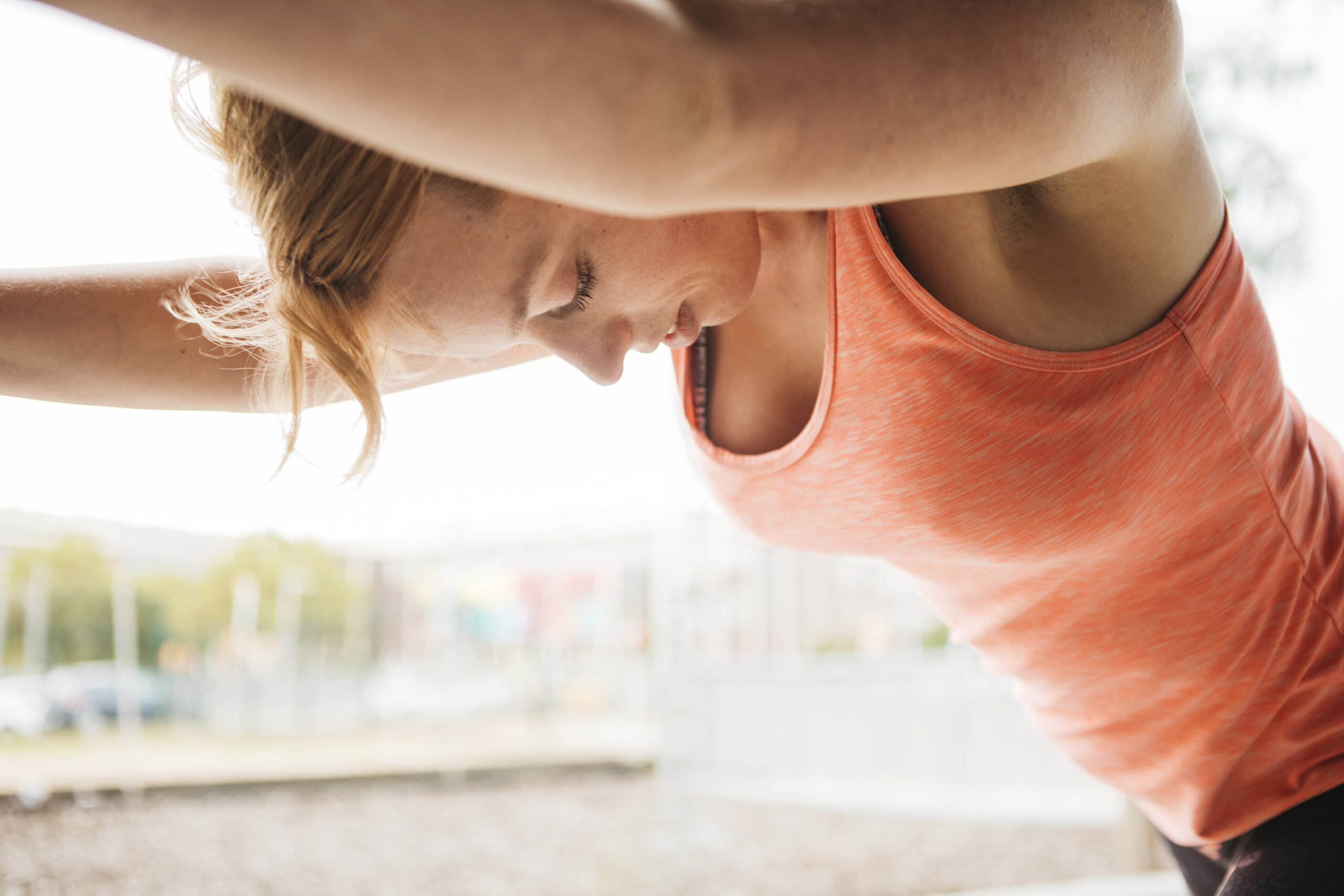 sporty woman stretching urban environment scaled